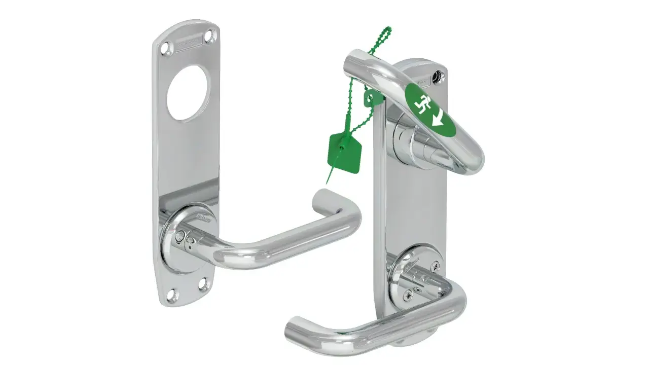 Chrome door handles, one with an emergency exit sign and green tag.