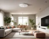 En modern lägenhet med en Ring Alarm brandvarnare i taket. Vardagsrummet är ljust och luftigt med en stor soffa, växter och ett matbord.
